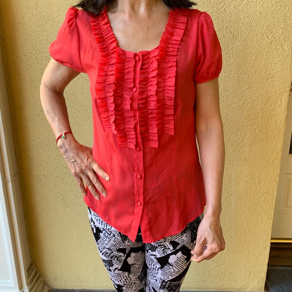 Gorgeous orange ruffle button down shirt.